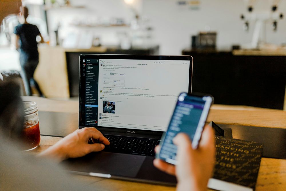 Comunicação de equipa em marketing digital através de portátil e telemóvel. Marketing Digital para PME